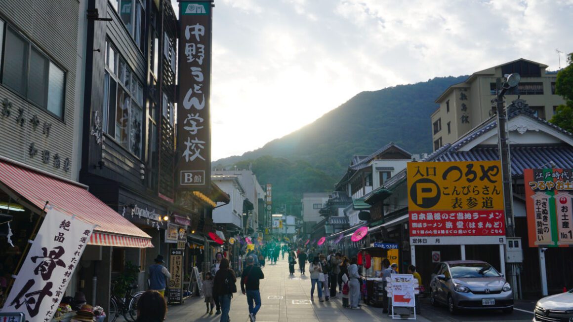 The main street of Kotohira, with a mountain in the background as the sun sets